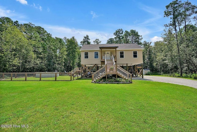 view of jungle gym featuring stairs, fence, and a yard