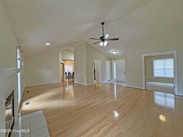 unfurnished living room featuring ceiling fan, high vaulted ceiling, and light hardwood / wood-style flooring