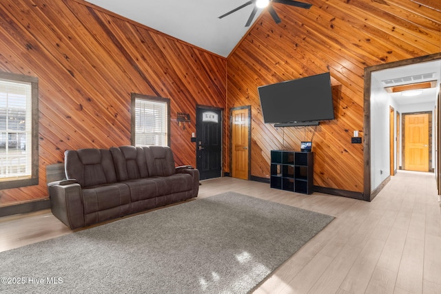 living area featuring wood finished floors, a ceiling fan, visible vents, and high vaulted ceiling