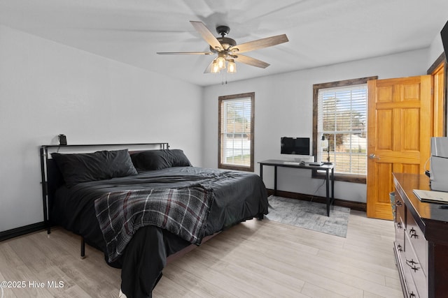 bedroom featuring ceiling fan, baseboards, and light wood-style floors