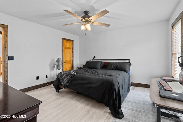 bedroom with light wood-type flooring, baseboards, and ceiling fan