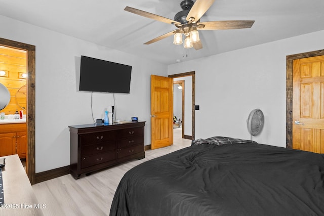 bedroom featuring ceiling fan, connected bathroom, baseboards, and light wood-style flooring