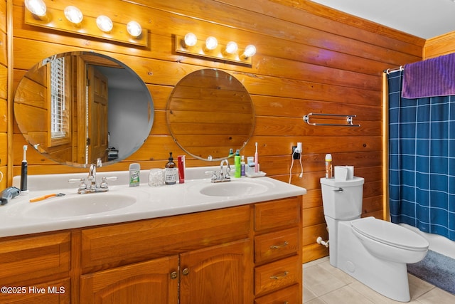 full bath with a sink, toilet, double vanity, and tile patterned floors