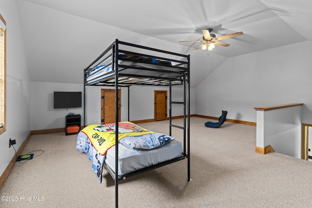 carpeted bedroom featuring lofted ceiling and baseboards