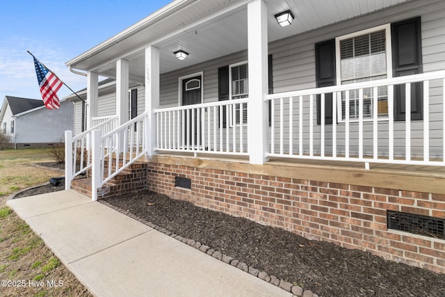 entrance to property with crawl space and a porch