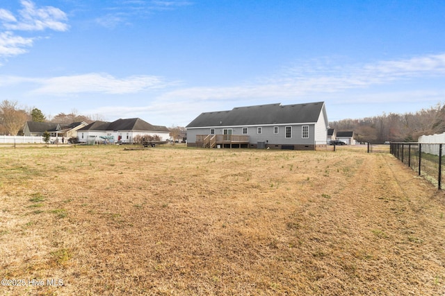 view of yard featuring a wooden deck and fence