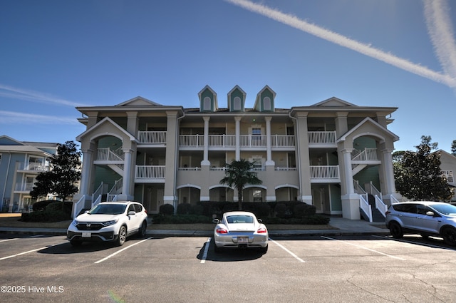 view of building exterior featuring uncovered parking