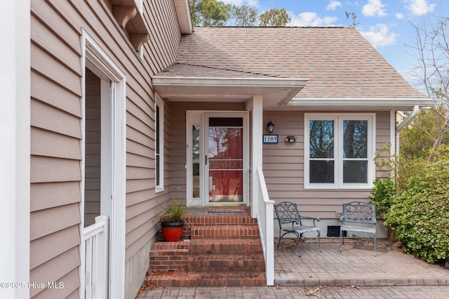 entrance to property with roof with shingles