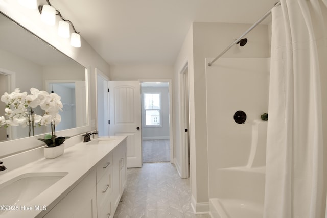 bathroom featuring walk in shower and vanity