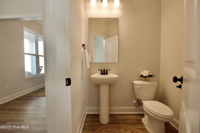 bathroom featuring sink, toilet, and hardwood / wood-style floors