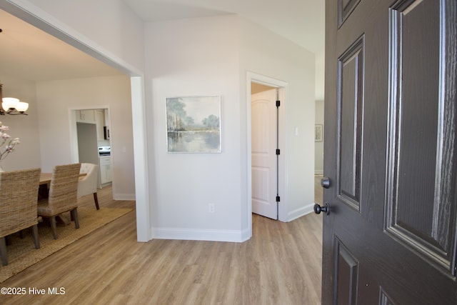 entrance foyer with an inviting chandelier and light wood-type flooring