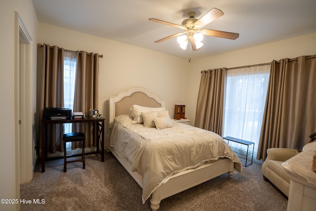 bedroom with ceiling fan and dark colored carpet