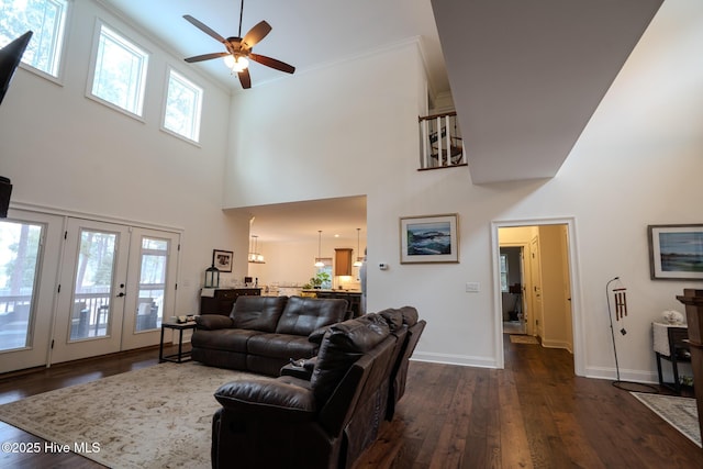 living area featuring ceiling fan, baseboards, dark wood-type flooring, and french doors