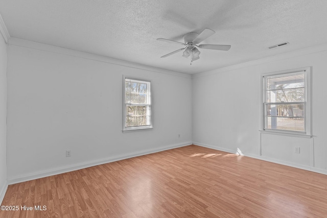 spare room featuring a textured ceiling, crown molding, ceiling fan, and light hardwood / wood-style flooring