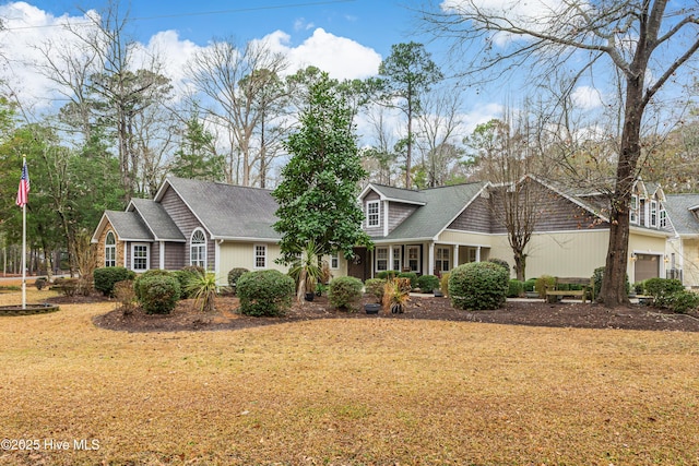 view of front of house with a front yard and a garage