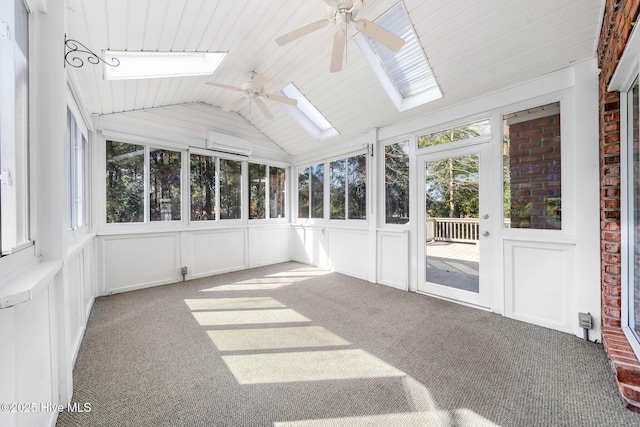 unfurnished sunroom featuring a wall unit AC, vaulted ceiling with skylight, ceiling fan, and wood ceiling