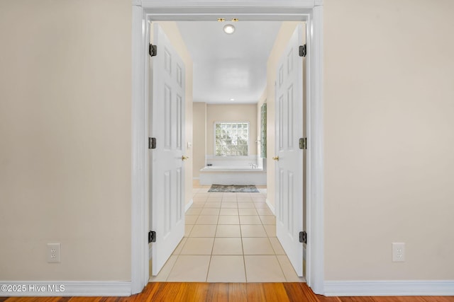 corridor with light tile patterned floors