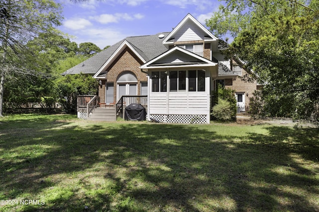 view of front of home with a front lawn and a sunroom