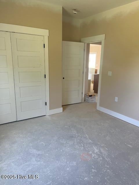 101 Mill Creek Rd, Edenton, NC 27932 - unfurnished bedroom featuring concrete flooring, a closet, and baseboards