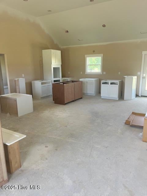 101 Mill Creek Rd, Edenton, NC 27932 - kitchen featuring a kitchen island, lofted ceiling, concrete flooring, and open floor plan