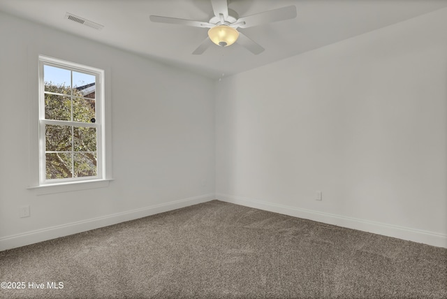 carpeted spare room featuring plenty of natural light, visible vents, ceiling fan, and baseboards