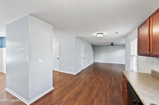 unfurnished living room featuring ceiling fan and dark hardwood / wood-style floors