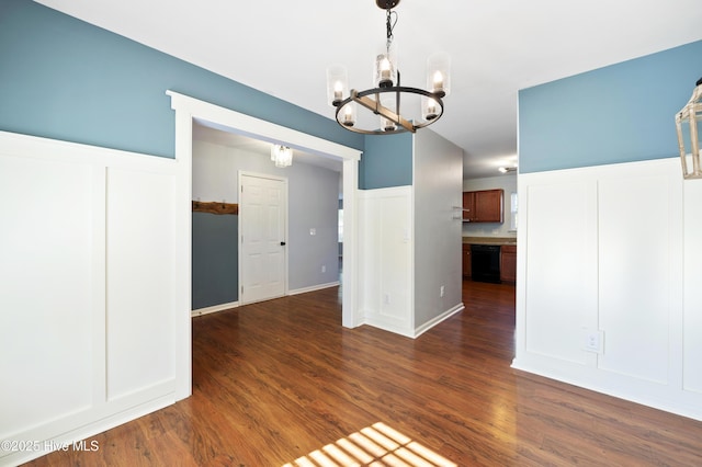 unfurnished dining area with dark hardwood / wood-style flooring and a chandelier