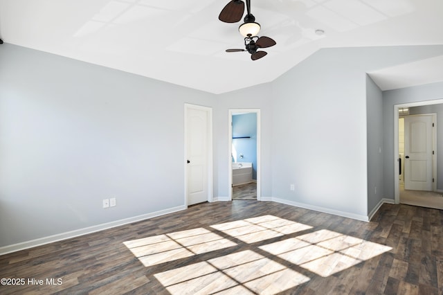 unfurnished bedroom featuring dark wood-type flooring, vaulted ceiling, ceiling fan, and ensuite bath