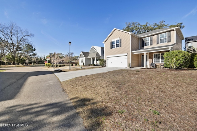 view of front facade featuring a front yard, a garage, and a porch