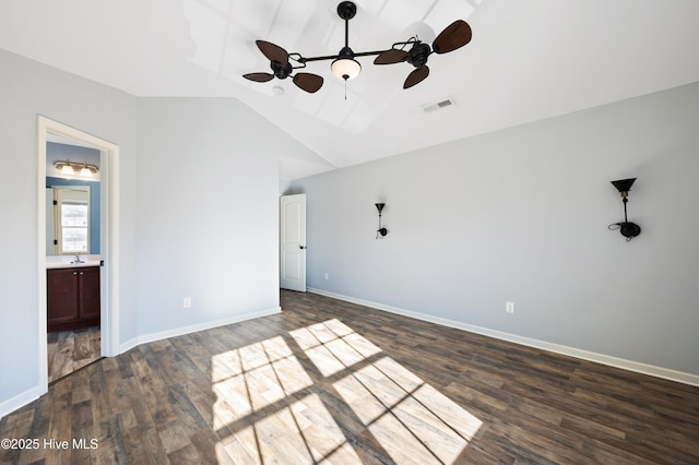 unfurnished bedroom featuring dark hardwood / wood-style flooring, ensuite bathroom, sink, and lofted ceiling