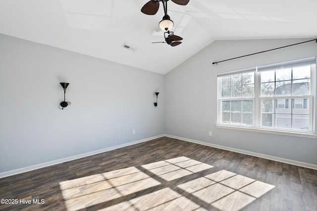 spare room featuring dark wood-type flooring, lofted ceiling, and ceiling fan