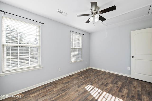 spare room with dark wood-type flooring and ceiling fan