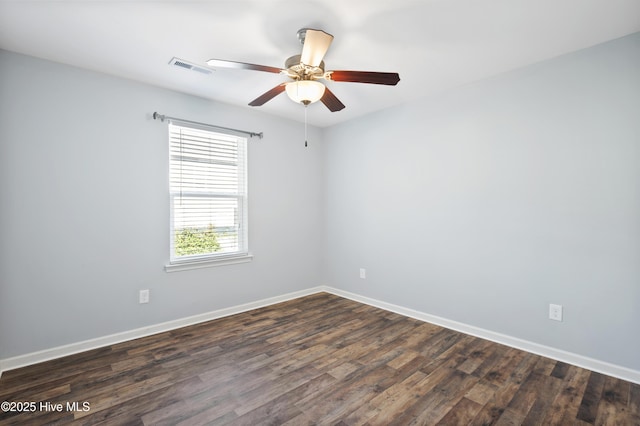 empty room with dark hardwood / wood-style flooring and ceiling fan