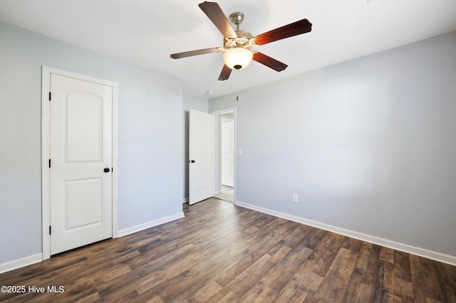 unfurnished bedroom featuring ceiling fan and dark wood-type flooring