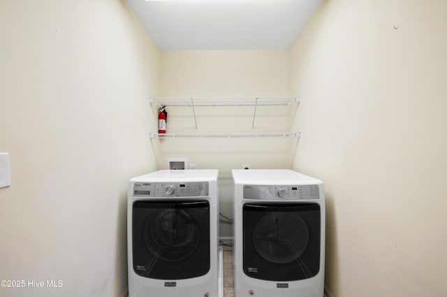 clothes washing area with washing machine and clothes dryer