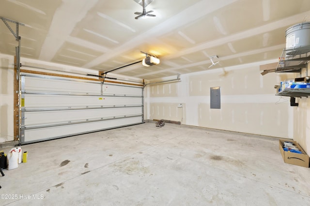 garage with a garage door opener and electric panel