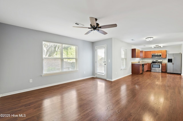 unfurnished living room with dark wood-type flooring and ceiling fan