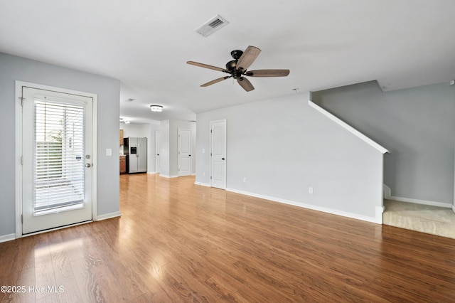 unfurnished living room featuring light hardwood / wood-style flooring and ceiling fan