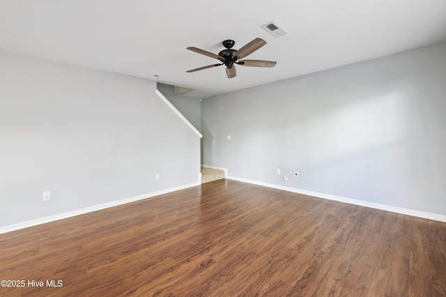 unfurnished room with dark hardwood / wood-style flooring and ceiling fan