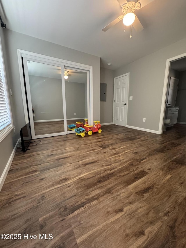 unfurnished room featuring dark wood-style floors, ceiling fan, and baseboards