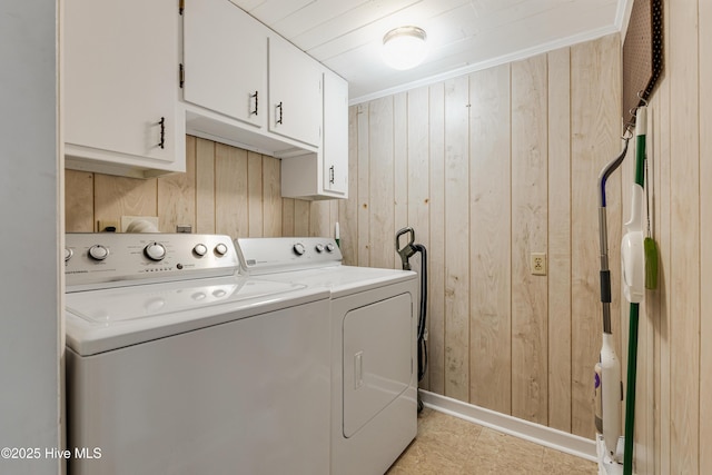 laundry room with cabinet space, independent washer and dryer, crown molding, and wood walls