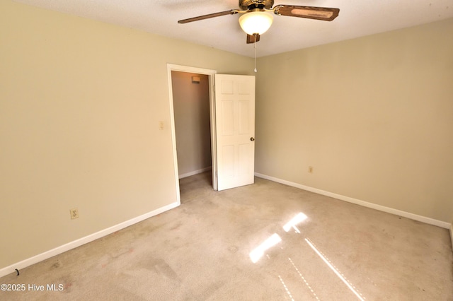 interior space featuring carpet, baseboards, and ceiling fan