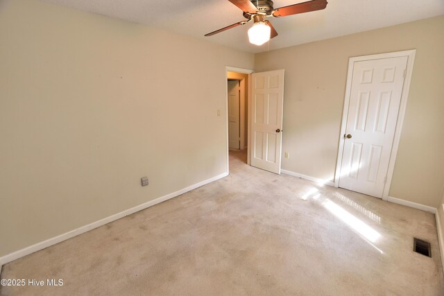 unfurnished bedroom featuring visible vents, baseboards, carpet flooring, and ceiling fan