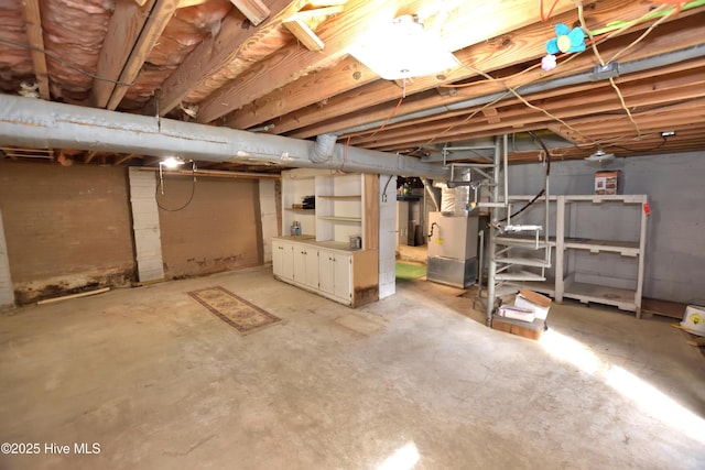 unfinished basement featuring heating unit
