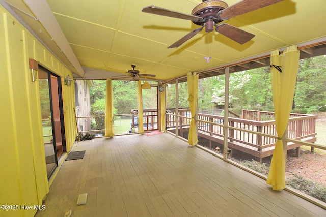 unfurnished sunroom featuring ceiling fan
