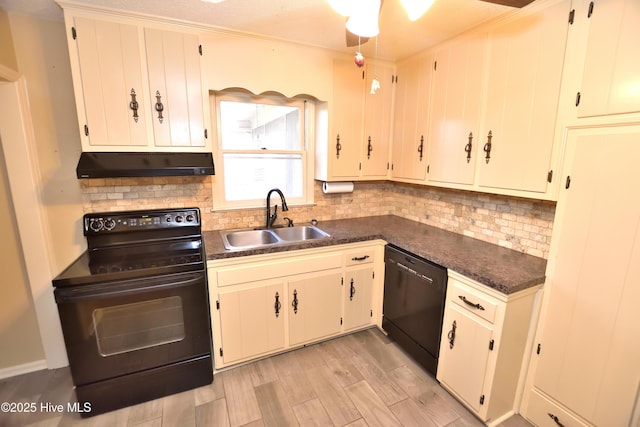 kitchen featuring under cabinet range hood, a sink, black appliances, and backsplash