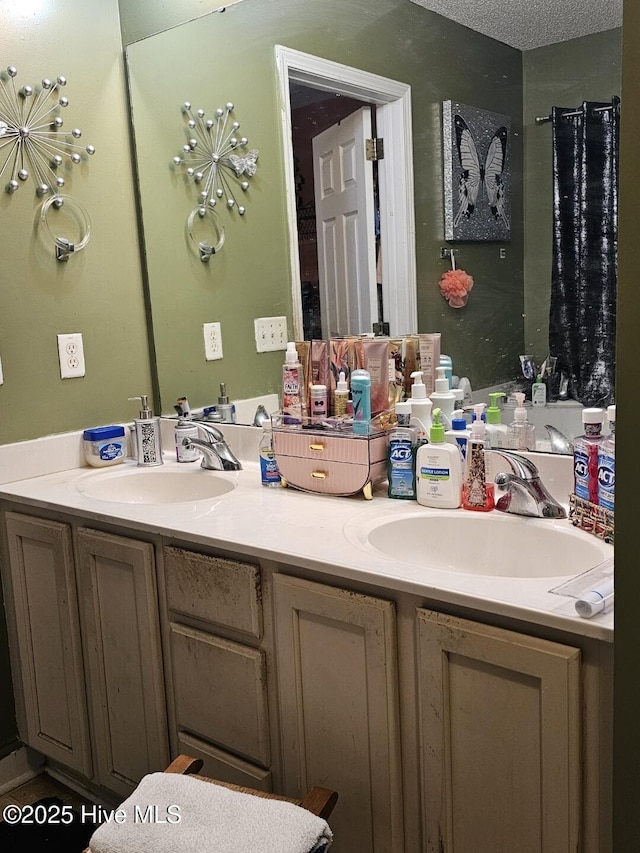 bathroom with vanity and a textured ceiling