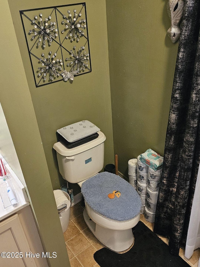 bathroom with toilet and tile patterned flooring