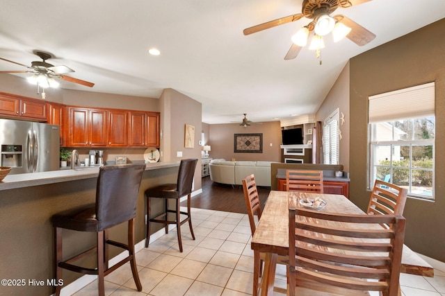 dining space featuring recessed lighting, a fireplace, ceiling fan, and light tile patterned floors