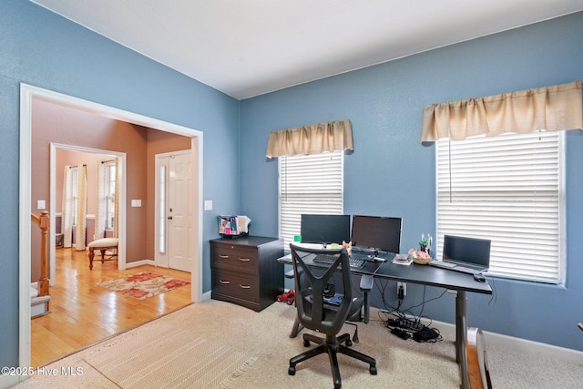 office space featuring light wood-style flooring and baseboards